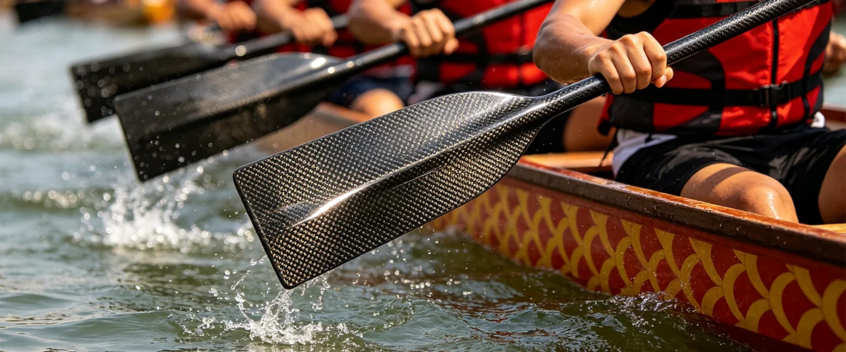 carbon fiber dragon boat paddle blade close-up showing 3K twill weave pattern and precision CNC cut edges