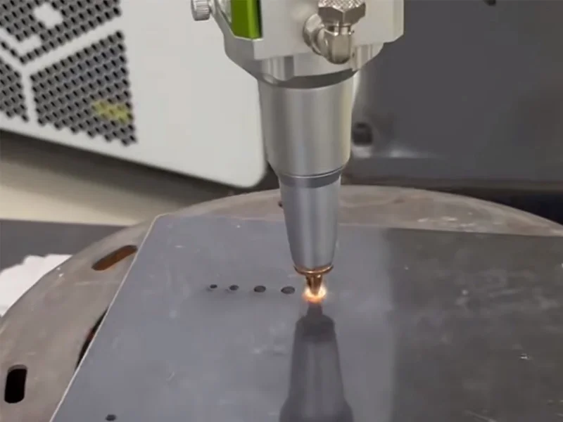 Laser cutting carbon fiber sheet showing precision beam and heat affected zone
