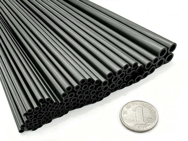 Micro carbon fiber tubes shown next to coins for size reference highlighting 2.5mm to 10mm diameter range