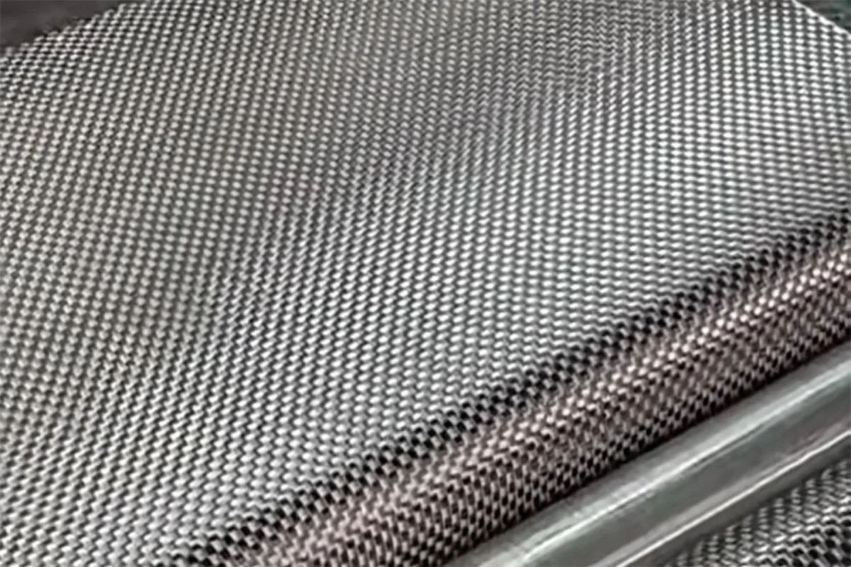 T1100 carbon fiber weave pattern close-up showing twill surface detail