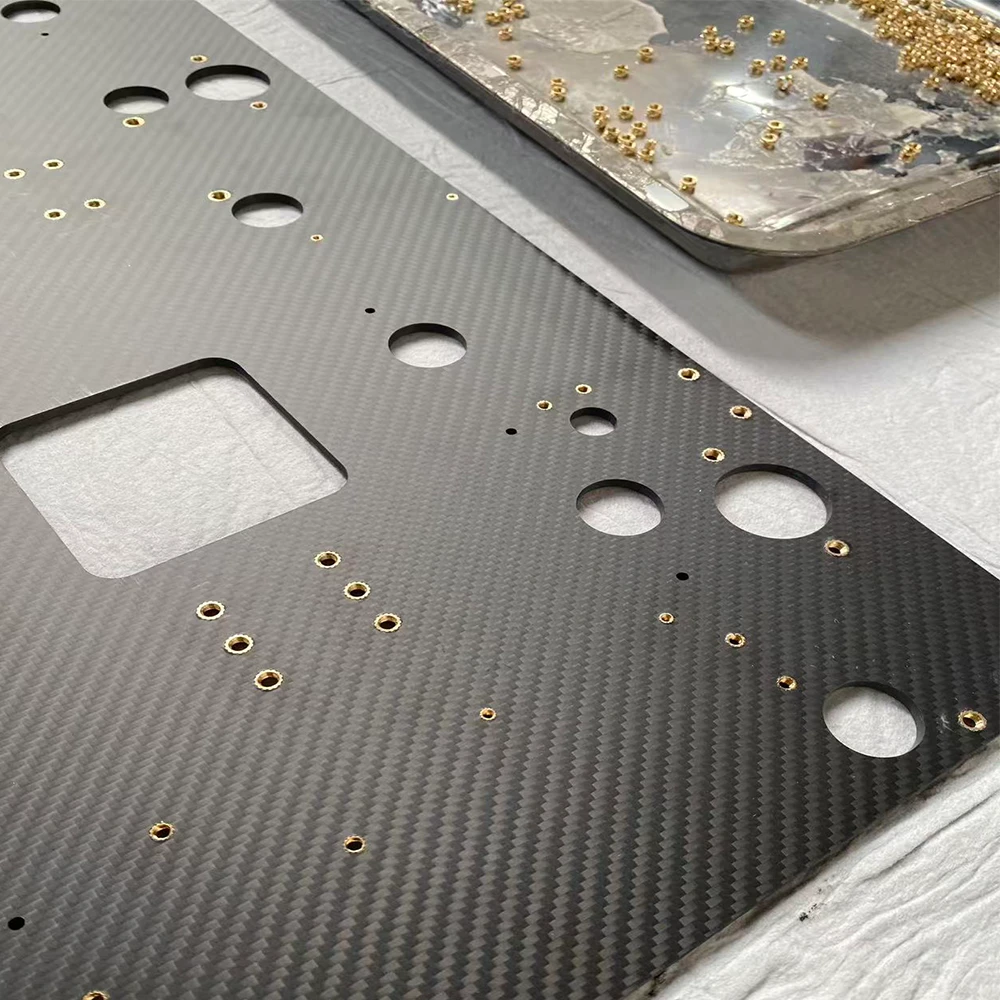 Carbon fiber plate with threaded inserts back view, CNC machined smooth surface finish