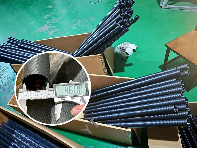 Close-up of 1.5m carbon fiber tube ends with 80mm inner diameter during factory measurement at YTCarbon